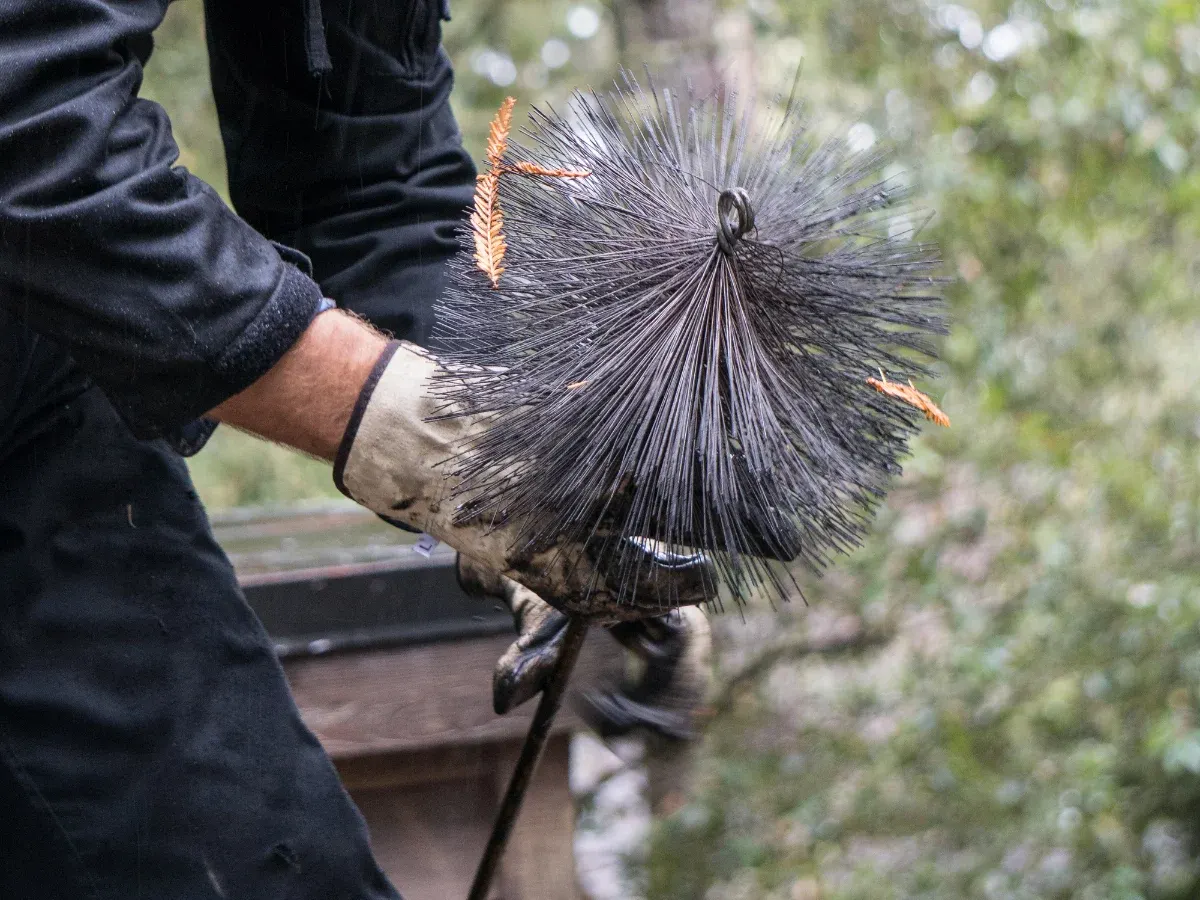 Chimney brush with soot on its bristles