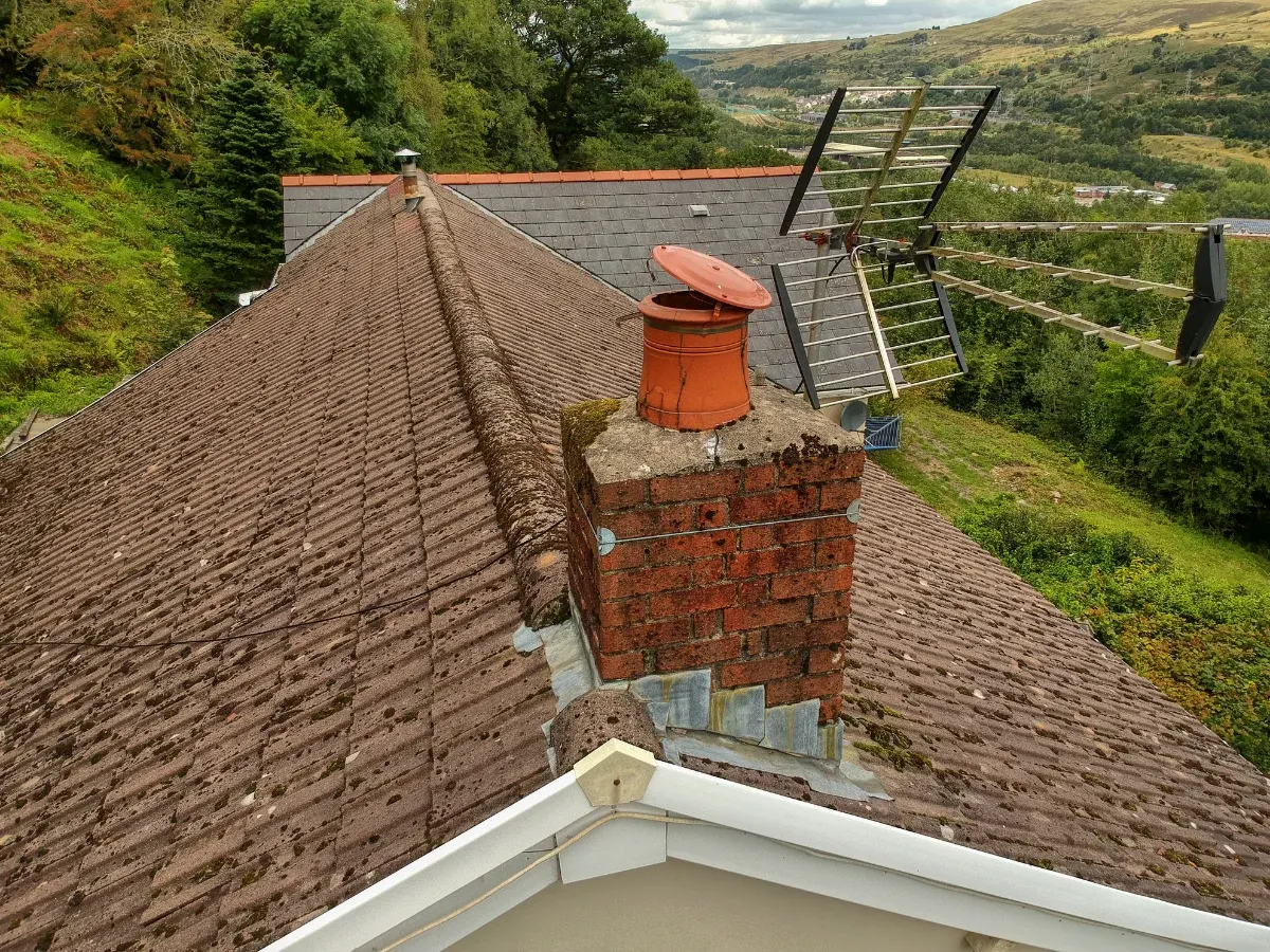 Brick chimney and access ladder on a roof