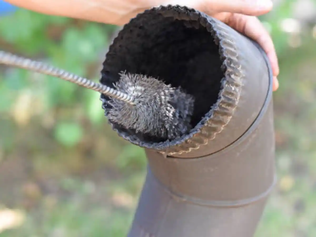 Brush clearing the inside of a stovepipe