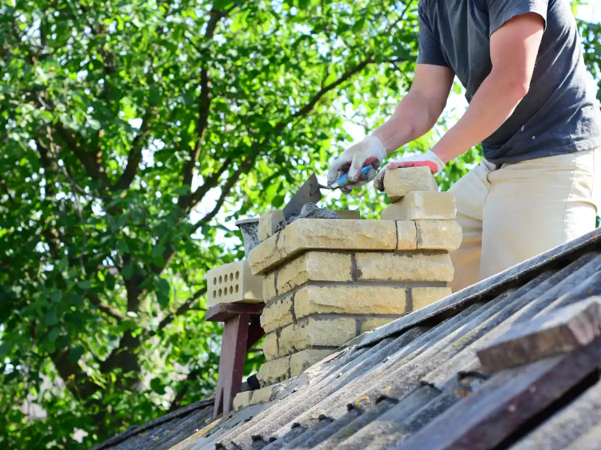 Technician repairing chimney brickwork